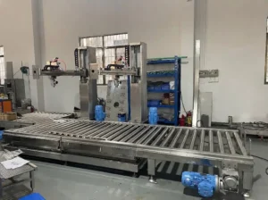 Z-MIXER automatic 200L drum filling machine for epoxy resin packaging, featuring a heavy-duty stainless steel roller conveyor and dual filling heads.